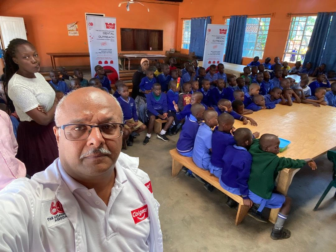 Dr. Biren N teaching young kids about dental services